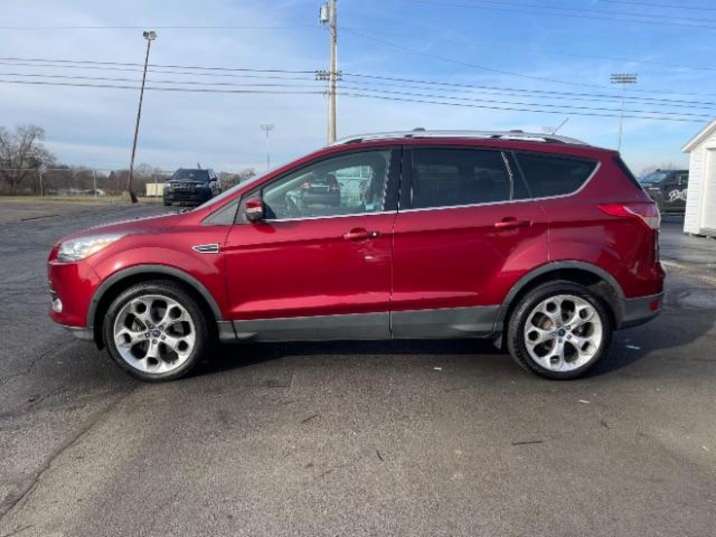 2013 Ruby Red Metallic Tinted Ford Escape Titanium 4WD (1FMCU9J92DU) with an 2.0L L4 DOHC 16V engine, 6-Speed Automatic transmission, located at 880 E. National Road, Vandalia, OH, 45377, (937) 908-9800, 39.891918, -84.183594 - Photo#4