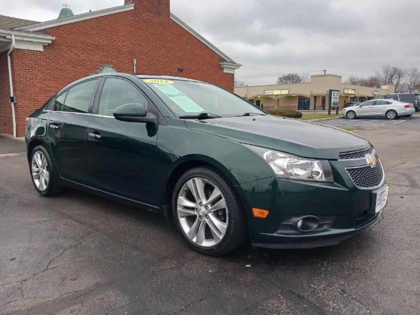 2014 Rainforest Green Metallic Chevrolet Cruze LTZ Auto (1G1PG5SB9E7) with an 1.4L L4 DOHC 16V TURBO engine, 6-Speed Automatic transmission, located at 1099 N County Rd 25A , Troy, OH, 45373, (937) 908-9800, 40.057079, -84.212883 - Photo#0