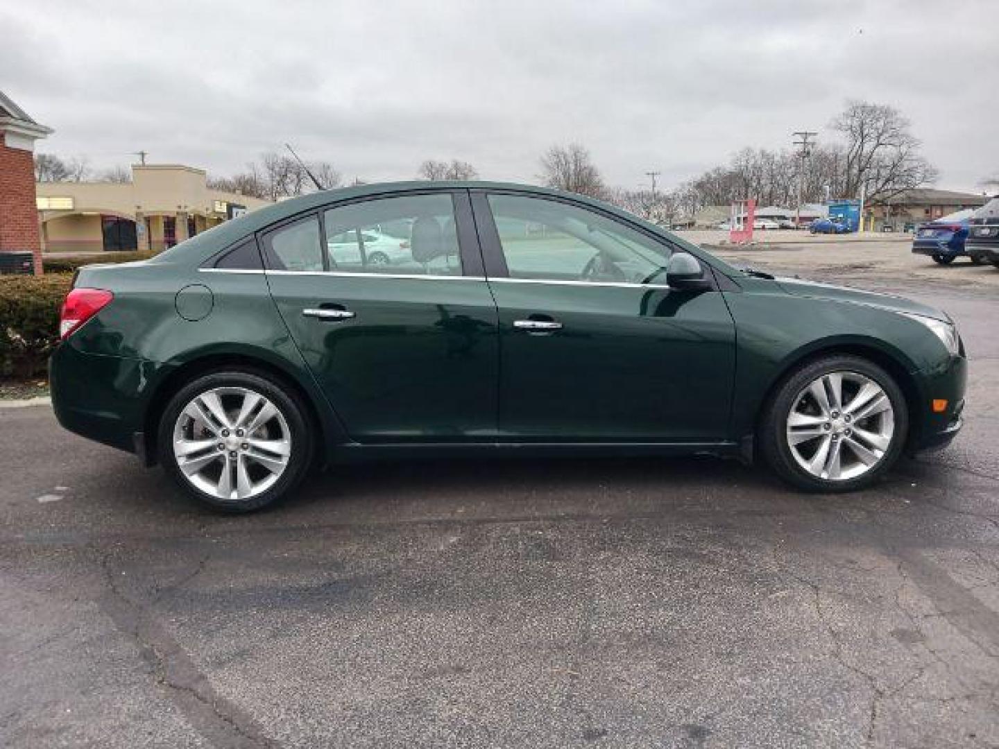 2014 Rainforest Green Metallic Chevrolet Cruze LTZ Auto (1G1PG5SB9E7) with an 1.4L L4 DOHC 16V TURBO engine, 6-Speed Automatic transmission, located at 1099 N County Rd 25A , Troy, OH, 45373, (937) 908-9800, 40.057079, -84.212883 - Photo#4