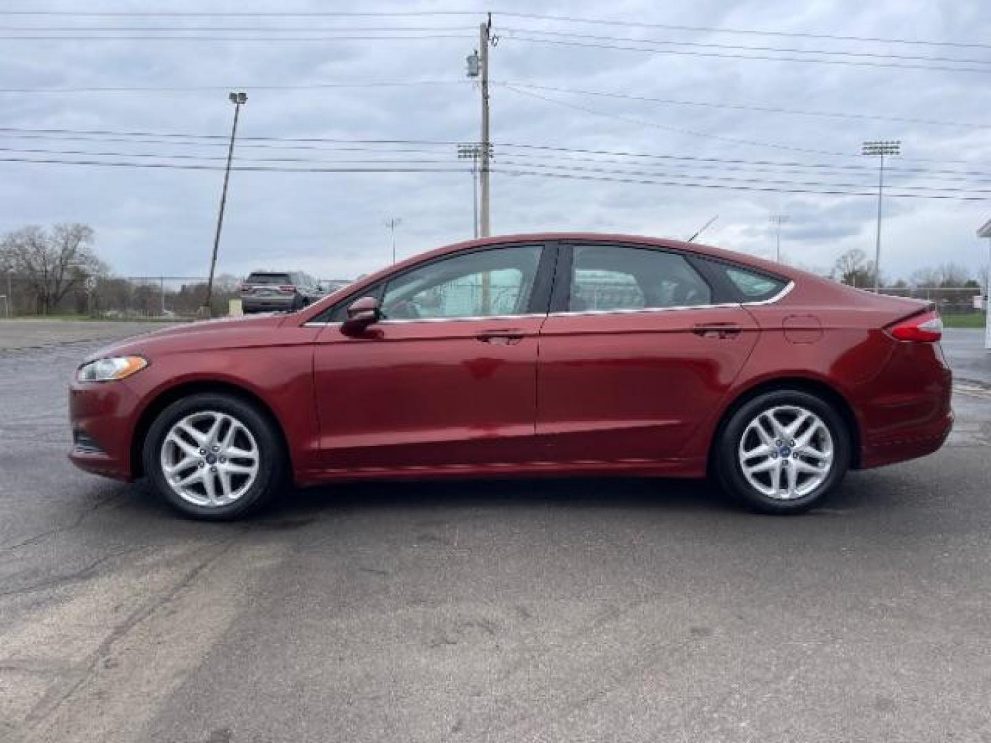 2014 Ruby Red Met Tinted CC Ford Fusion SE (3FA6P0H74ER) with an 2.5L L4 DOHC 16V engine, located at 1099 N County Rd 25A , Troy, OH, 45373, (937) 908-9800, 40.057079, -84.212883 - Photo#2