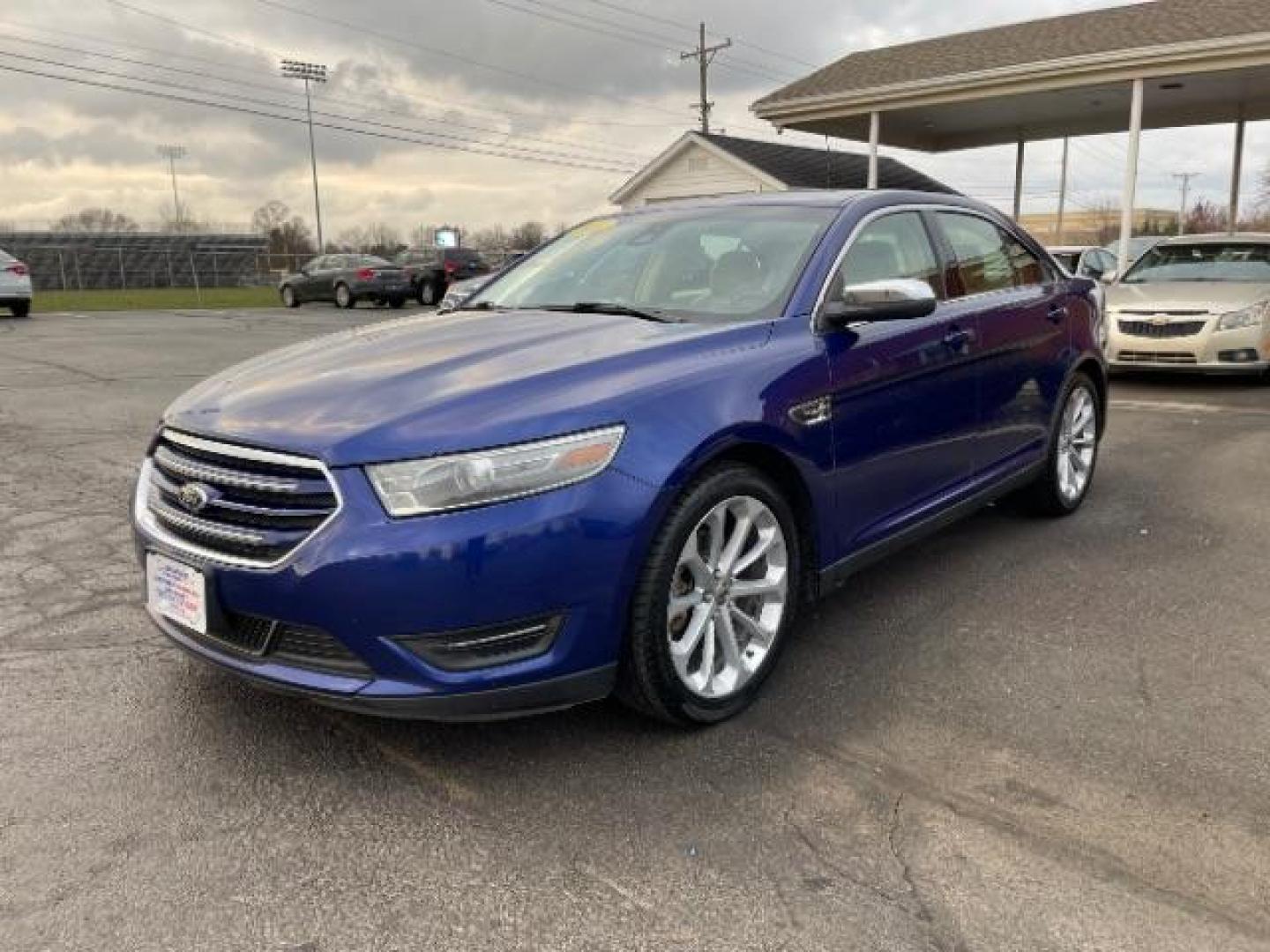 2014 Deep Impact Blue Metallic Ford Taurus Limited AWD (1FAHP2J86EG) with an 3.5L V6 DOHC 24V engine, 6-Speed Automatic transmission, located at 1230 East Main St, Xenia, OH, 45385, (937) 908-9800, 39.688026, -83.910172 - Photo#1