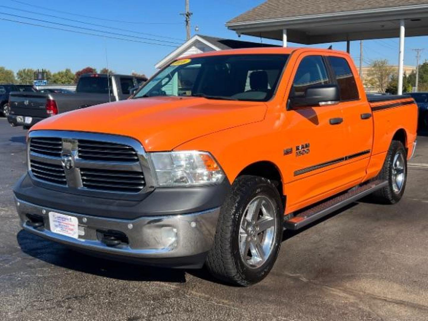 2016 Low Vol Omaha Orange RAM 1500 SLT Quad Cab 4WD (1C6RR7GT3GS) with an 5.7L V8 OHV 16V engine, 8-Speed Automatic transmission, located at 1099 N County Rd 25A , Troy, OH, 45373, (937) 908-9800, 40.057079, -84.212883 - Photo#2