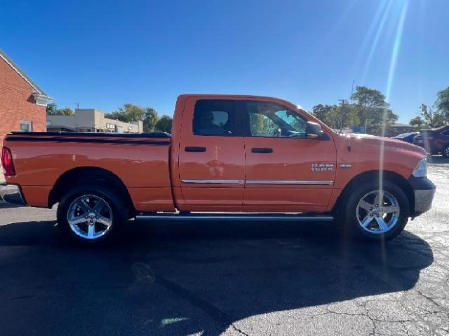 2016 Low Vol Omaha Orange RAM 1500 SLT Quad Cab 4WD (1C6RR7GT3GS) with an 5.7L V8 OHV 16V engine, 8-Speed Automatic transmission, located at 1099 N County Rd 25A , Troy, OH, 45373, (937) 908-9800, 40.057079, -84.212883 - Photo#5