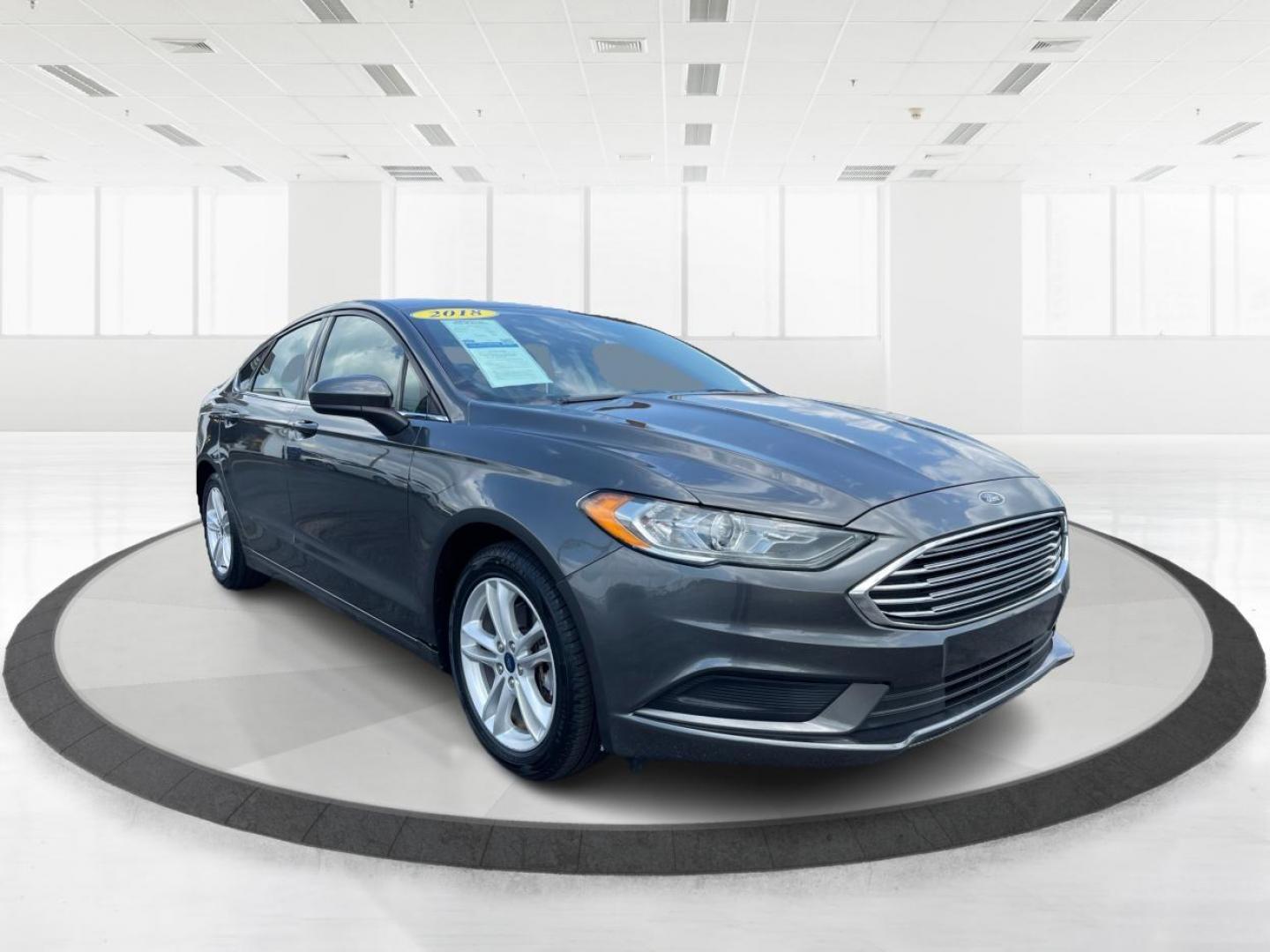 2018 Magnetic Metallic Ford Fusion SE (3FA6P0HD2JR) with an 1.5L L4 DOHC 16V engine, 6A transmission, located at 1099 N County Rd 25A , Troy, OH, 45373, (937) 908-9800, 40.057079, -84.212883 - Photo#0